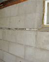 Severely buckling foundation walls in a home in Newport in need of repairs.