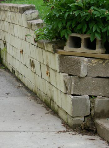 collapsing retaining wall with severe damage in Lillington