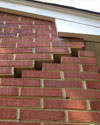 Serious damage to a foundation wall due to settlement of a home in Leland