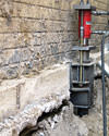 A completed installation of foundation push piers lifting a foundation in Spring Lake