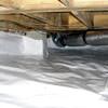 Bare floor joists in a sealed, insulated crawl space in New Bern.