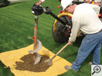 Auguring a hole in the earth for a foundation repair in Fort Bragg