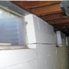 A foundation showing severe inward buckling along the windows in a Leland home.