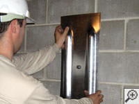 Mounting a foundation wall plate for an earth anchor installation in Kinston.