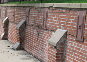 Rusted wall plate anchors in a retaining wall repair in Pembroke.