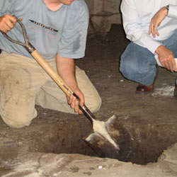 Digging a hole for the engineered fill used in a crawl space support system installation in Sanford