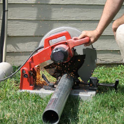 Cutting the support beam for a crawl space jack post outside a Camp Lejeune home.