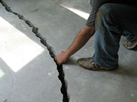 a severely damaged cracked concrete slab floor in Laurinburg