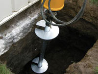 Installing a helical pier system in the earth around a foundation in Jacksonville