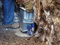 Securing a foundation footing bracket for a foundation repair system in Clinton.