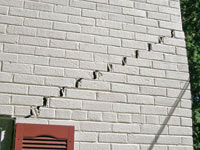 Stair-step cracks showing in a home foundation in Spring Lake