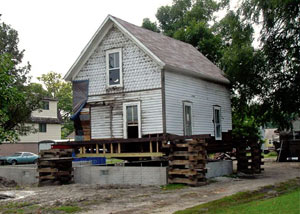 A severely damaged home foundation that is undergoing replacement in Saint Pauls.