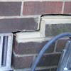 A closeup of a failed tuckpointing job where the brick cracked on a Red Springs home.
