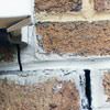 Failed crack repair showing old tuckpointing that cracked on a Greenville home.