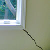 A long, diagonal crack that begins at a window corner of a Pinehurst home