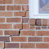 long jagged cracks starting at the corner of a window along a brick wall on a Hope Mills home