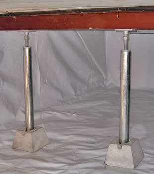 Crawl space jack posts installed in conjunction with a crawl space vapor barrier in Hubert