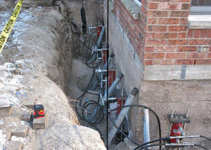 Foundation push piers installed around a house with a foundation settlement issues in Hubert
