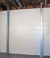 A steel i-beam system installed on a Red Springs foundation wall