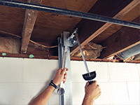 Straightening a foundation wall with the PowerBrace™ i-beam system in a Lumberton home.