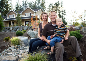 A happy family outside a home with a repaired foundation in Dudley