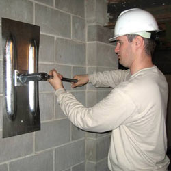 installing a wall anchor to repair an bowing foundation wall in Lumberton