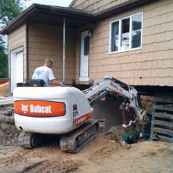 Excavating to expose the foundation walls and footings for a replacement job in Kinston