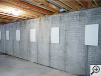 Wall anchor covers installed along a foundation wall that has been straightened in Red Springs.