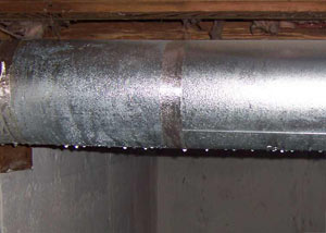 condensation collecting on an HVAC vent in a humid Fort Bragg basement