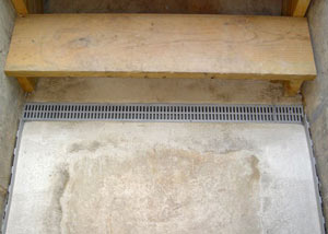 Our grated drain system installed on a leaking basement staircase in Hubert.