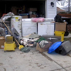 Soaked, wet personal items sitting in a driveway, including a washer and dryer in Sanford.