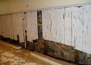 A wet, flooded finished basement in Hubert