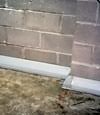 Our baseboard drain system installed on a corner in a Camp Lejeune basement.