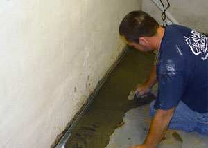 Restoring a concrete slab floor with fresh concrete after jackhammering it and installing a drain system in Dudley.