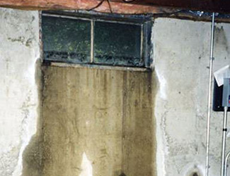 Water pouring out from a basement window in Goldsboro